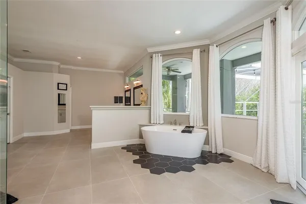 a view of a hallway with wooden floor and a bathroom