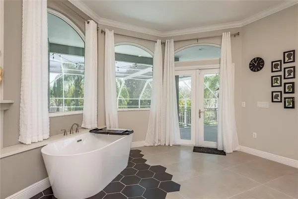 a living room with furniture and floor to ceiling windows