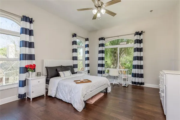 a bathroom with a toilet a sink a mirror a window and garden