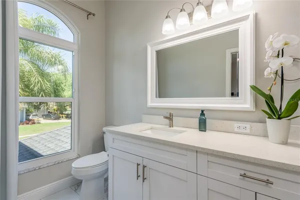 a view of a balcony with chairs and a potted plant