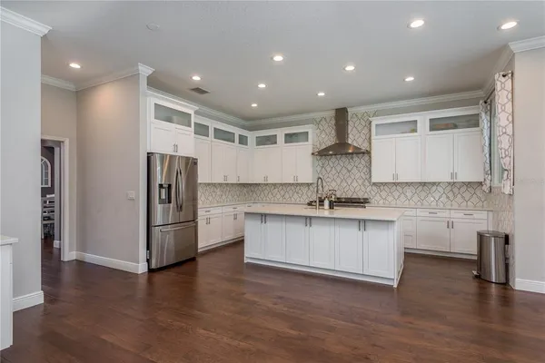 a kitchen with kitchen island granite countertop a sink and cabinets