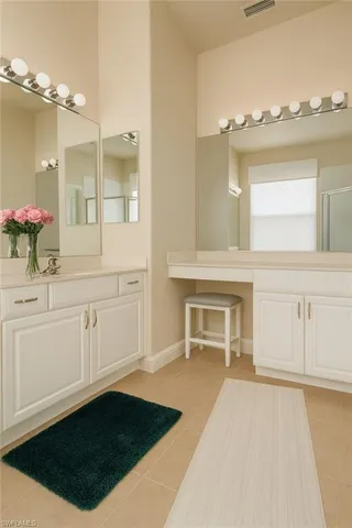 a bathroom with a sink vanity and mirror