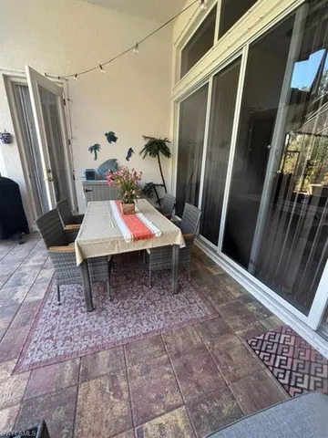 a backyard of a house with barbeque oven table and chairs