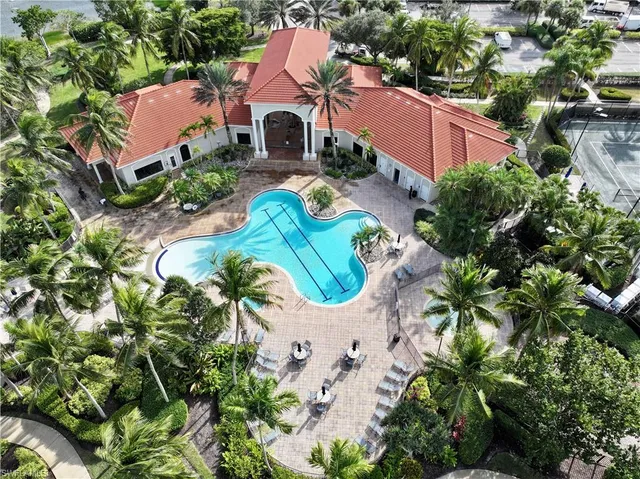 an aerial view of a house with a yard and swimming pool