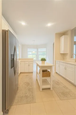 a kitchen with stainless steel appliances a refrigerator sink and cabinets
