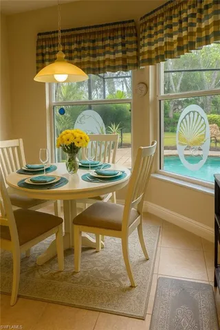 a dining room with furniture and window
