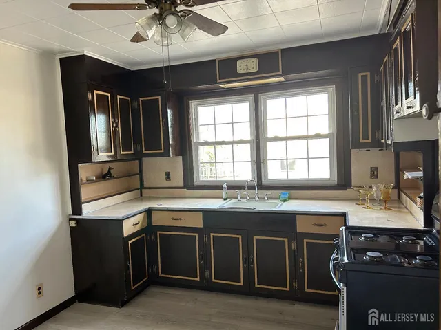 a kitchen with stainless steel appliances granite countertop a sink and a stove