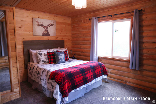 15253 Mill Road, Unit 62 Huntsville, UT 84317 - Photo 8 of 48 Carpeted room featuring natural wood paneling and a large window