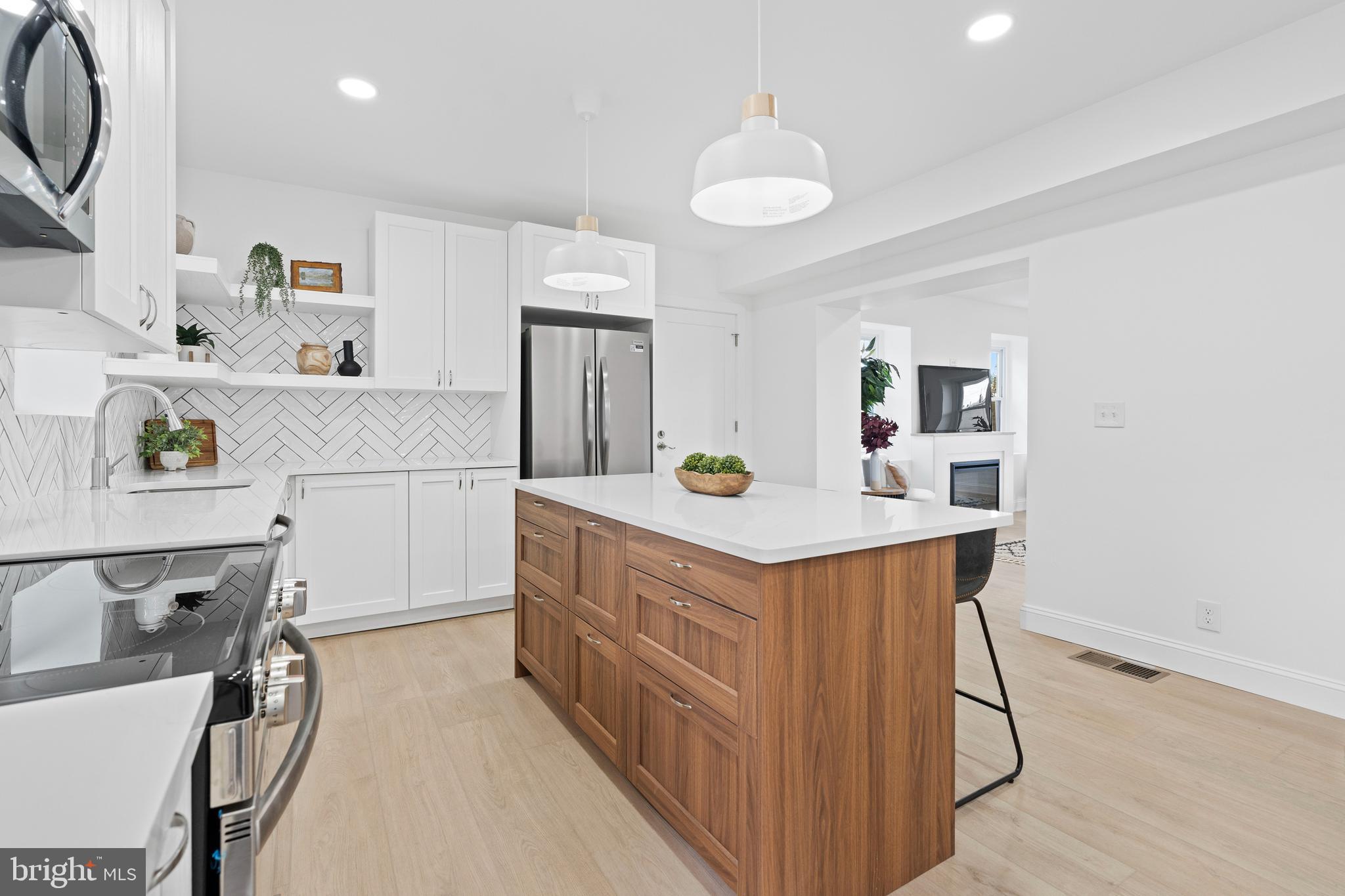 924 Bethlehem Pike Colmar, PA 18915 - Photo 5 of 47 a kitchen with stainless steel appliances a table and chairs