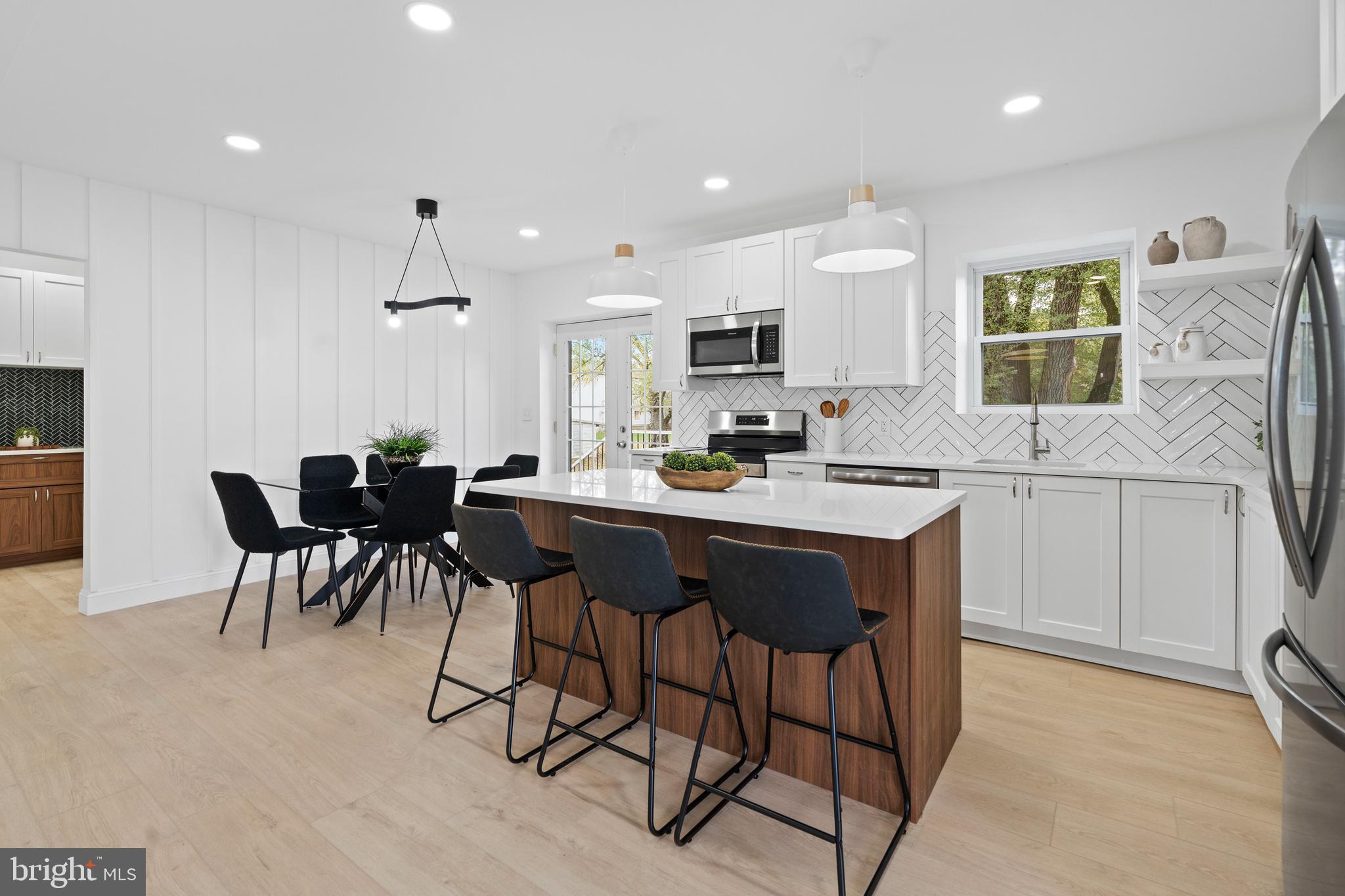 924 Bethlehem Pike Colmar, PA 18915 - Photo 8 of 47 a kitchen with a sink dining table and chairs