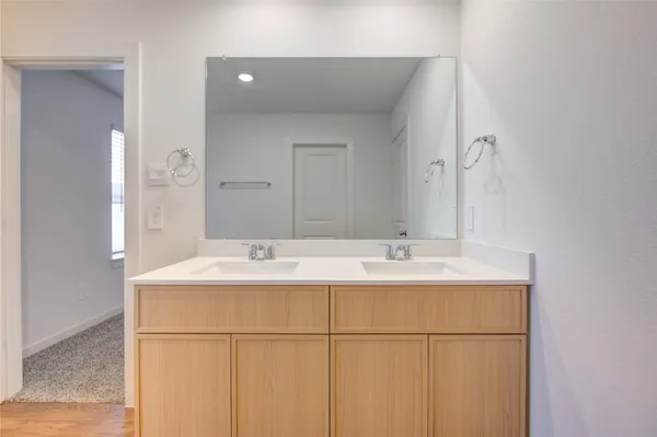 a bathroom with a double vanity sink and mirror