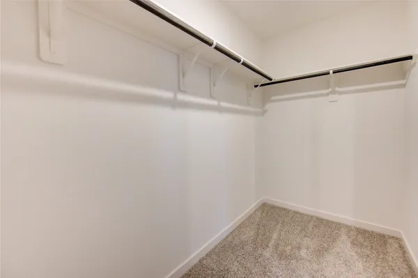 a view of an empty room and closet area