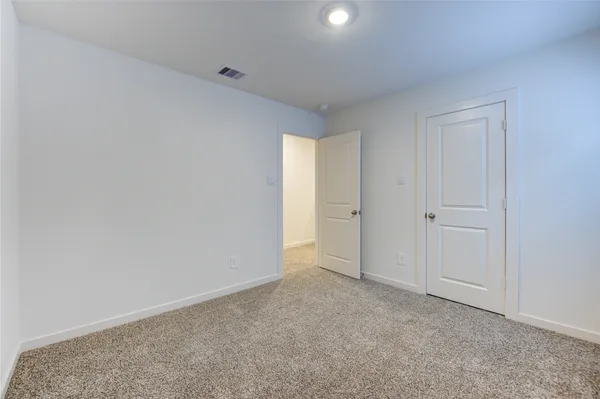 a view of an empty room and closet area
