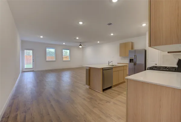 a kitchen with a sink and white cabinets