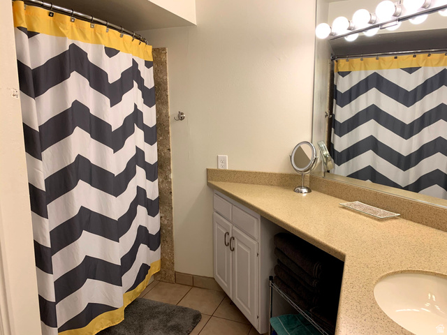 860 South Village Road, Unit B11 St. George, UT 84770 - Photo 15 of 19 Bathroom with vanity, a shower with shower curtain, and light tile patterned flooring