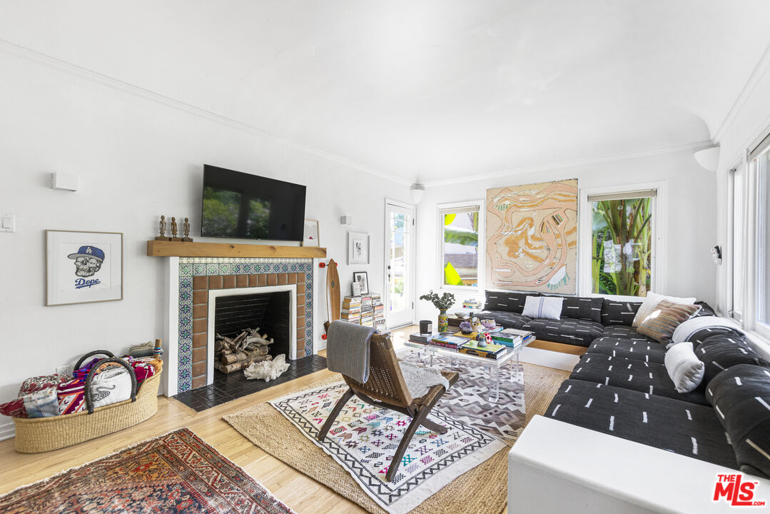 246 Robinson Road Pasadena, CA 91104 - Photo 4 of 43 a living room with furniture a flat screen tv and a fireplace