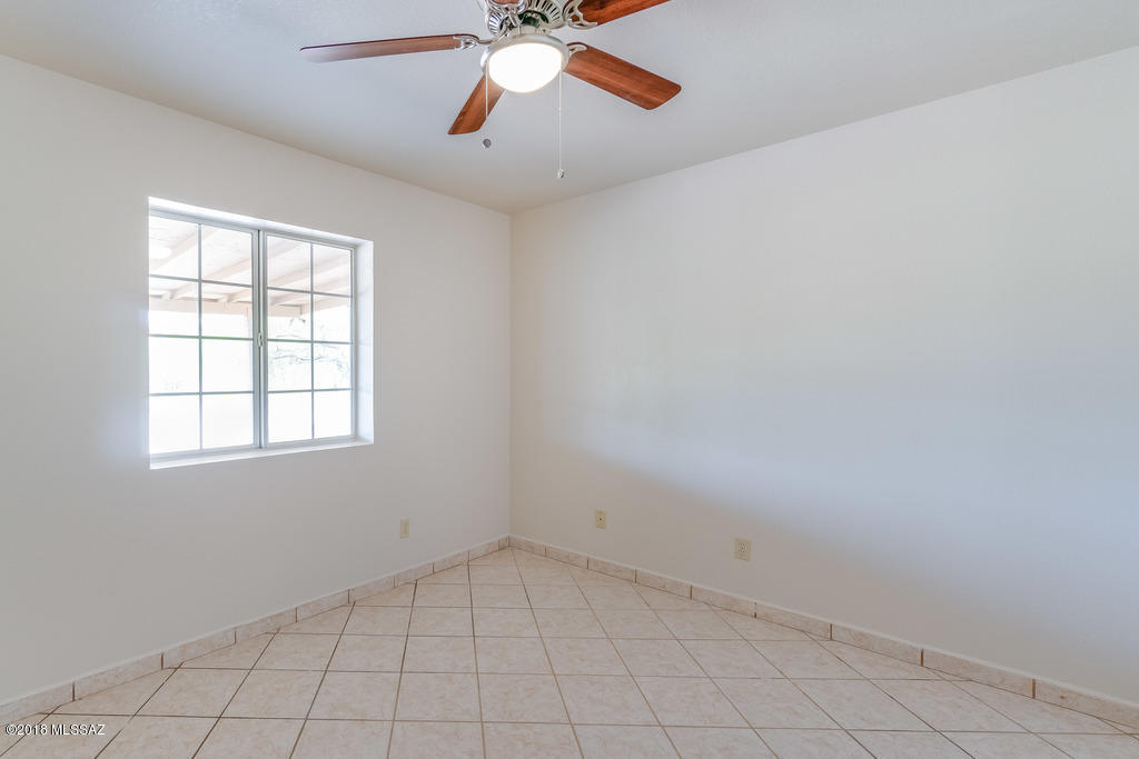 549 Valdez Court Rio Rico, AZ 85648 - Photo 24 of 27 an empty room with a window and a fan