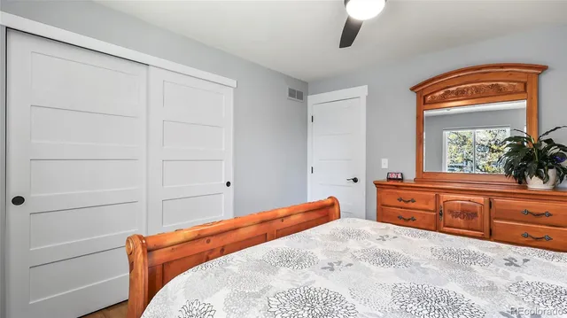 a bedroom with a bed and a dresser