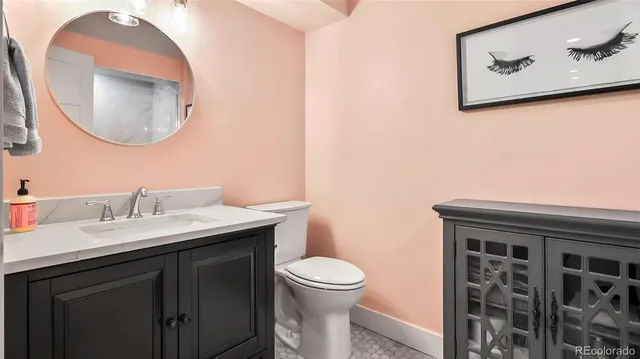 a bathroom with a toilet a sink and mirror