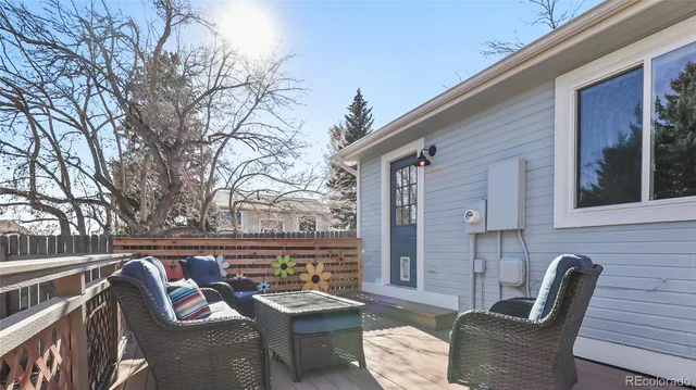 a view of a chairs and table in the balcony