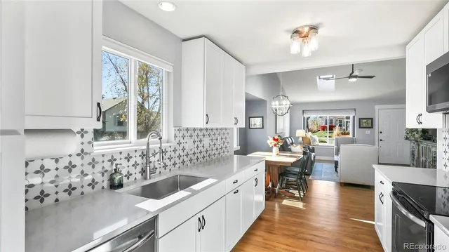 a kitchen with a sink stove and wooden cabinets