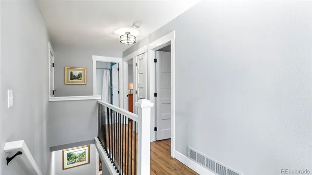 a view of a hallway with windows and stairs