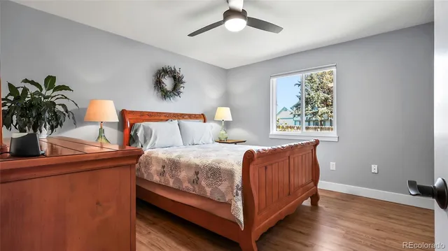 a bedroom with a bed and a potted plant