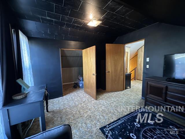 217 Main Street Kooskia, ID 83539 - Photo 19 of 34 Bedroom with a closet, vaulted ceiling, and carpet flooring