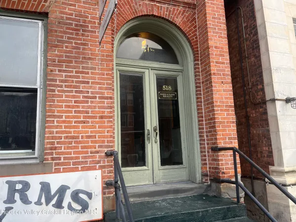 a view of a door of a house with a door and a window