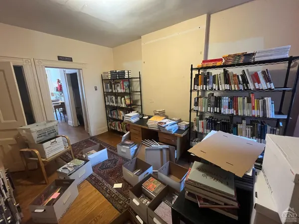 a work room with furniture and a book shelf