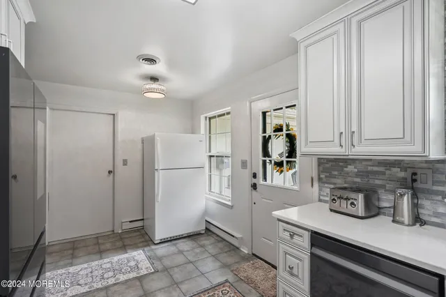 a kitchen with stainless steel appliances a refrigerator and cabinets