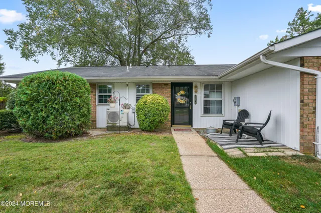 a view of a backyard with sitting area and garden