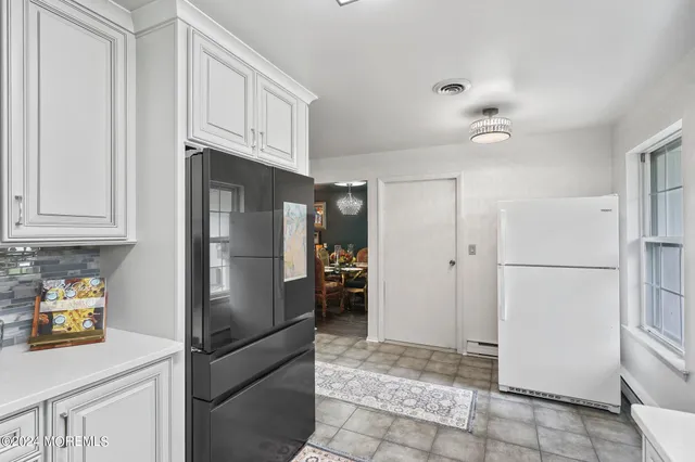 a kitchen with stainless steel appliances granite countertop a refrigerator and a stove top oven