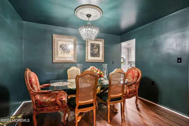 a view of a dining room with furniture and chandelier