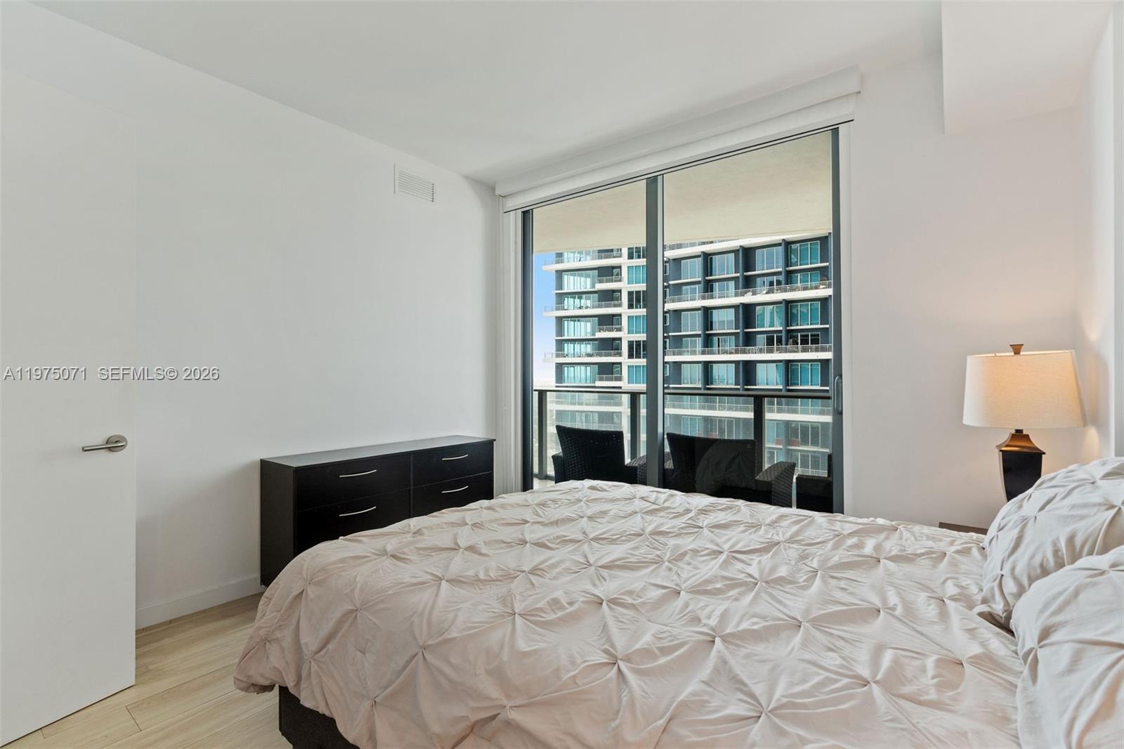 1300 South Miami Avenue, Unit 2807 Miami, FL 33130 - Photo 14 of 22 a bedroom with a bed and a window
