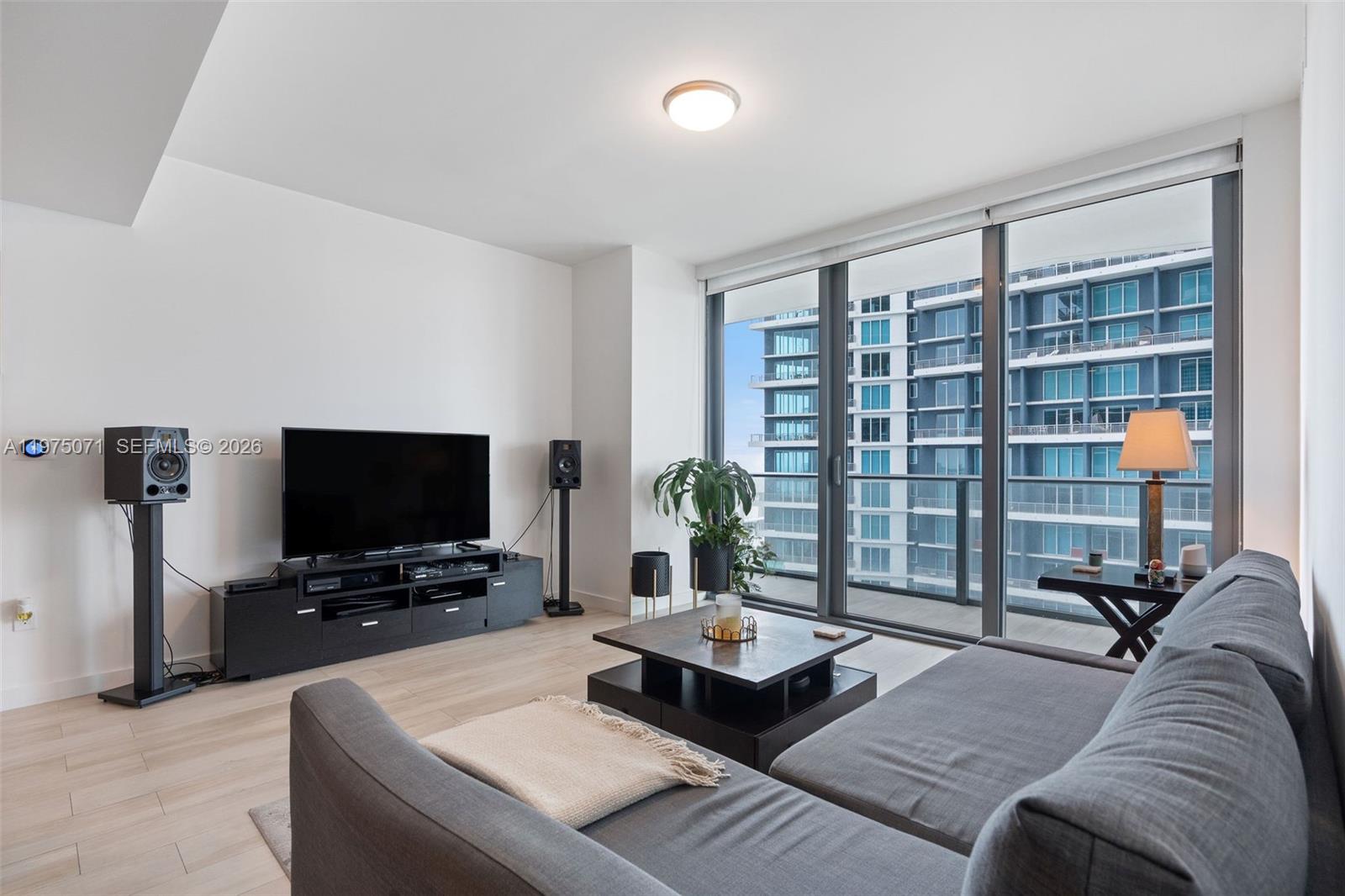 1300 South Miami Avenue, Unit 2807 Miami, FL 33130 - Photo 2 of 22 a living room with furniture and a flat screen tv