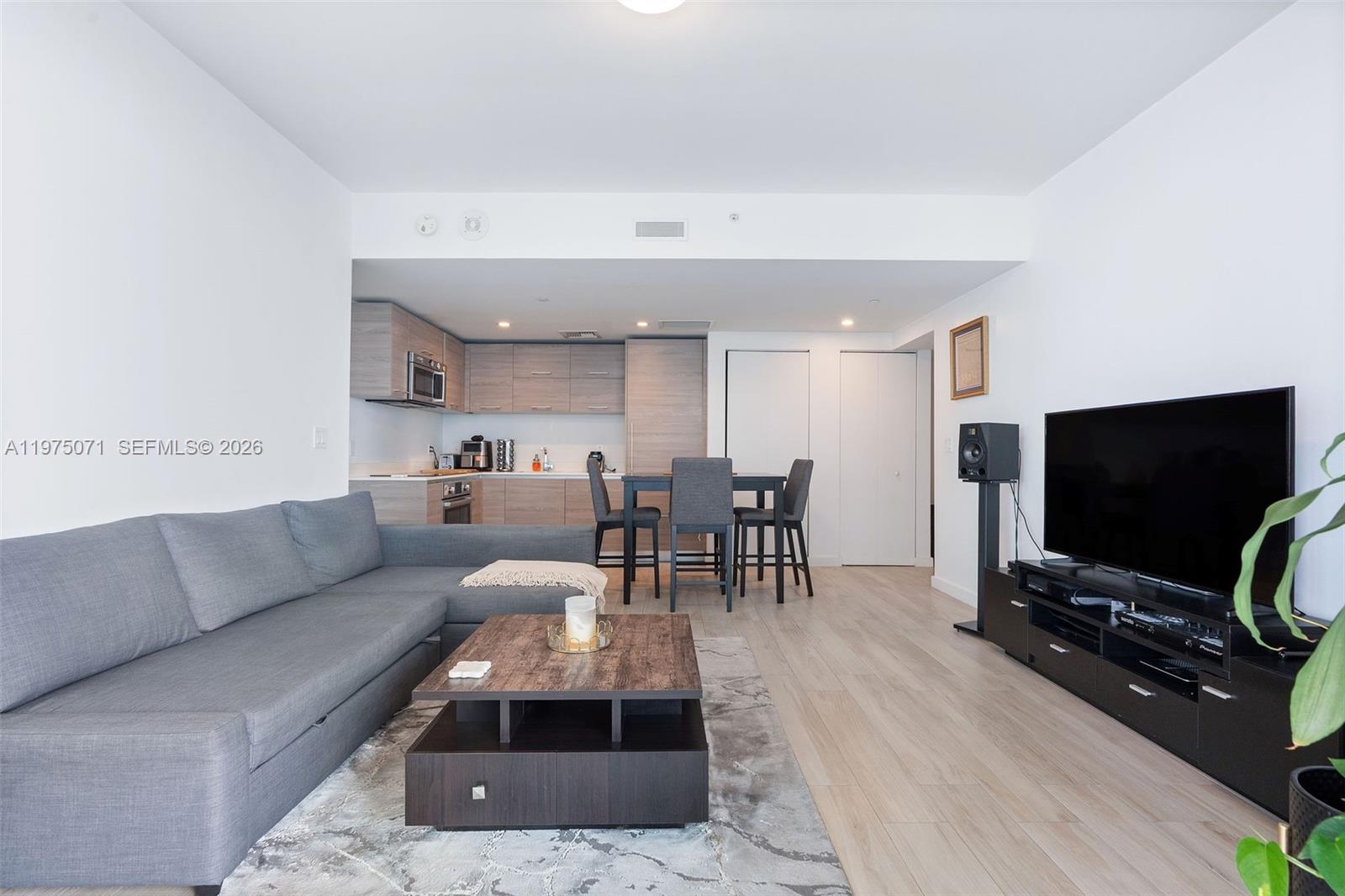 1300 South Miami Avenue, Unit 2807 Miami, FL 33130 - Photo 3 of 22 a living room with furniture and a flat screen tv