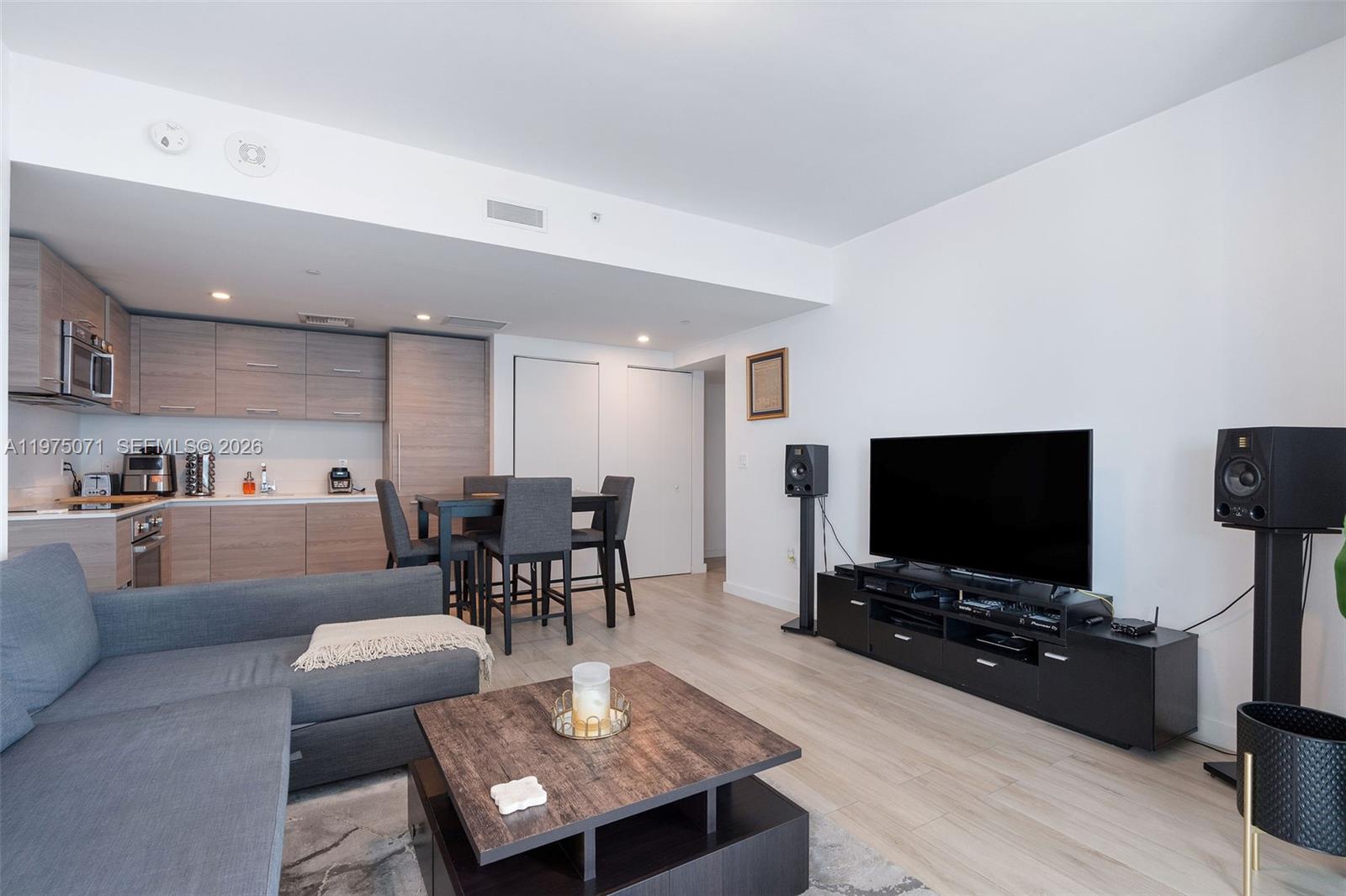 1300 South Miami Avenue, Unit 2807 Miami, FL 33130 - Photo 5 of 22 a living room with furniture and a flat screen tv