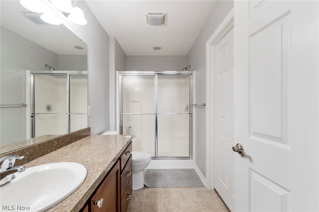 9151 Springfield Road, Unit 1902 Youngstown, OH 44514 - Photo 25 of 36 Bathroom with tile flooring, walk in shower, toilet, and large vanity