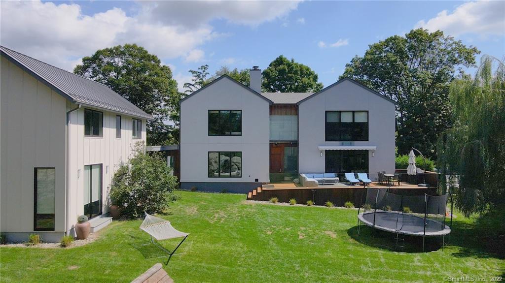 a front view of a house with a yard fire pit and outdoor seating