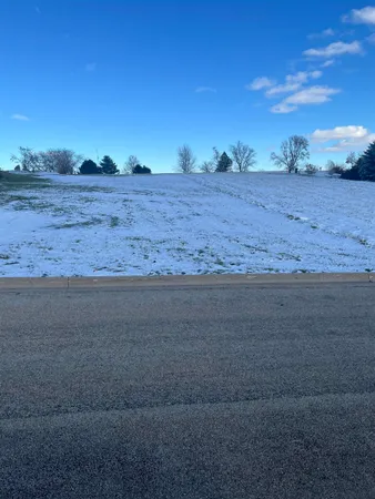 a view of dirt road with a building in the background
