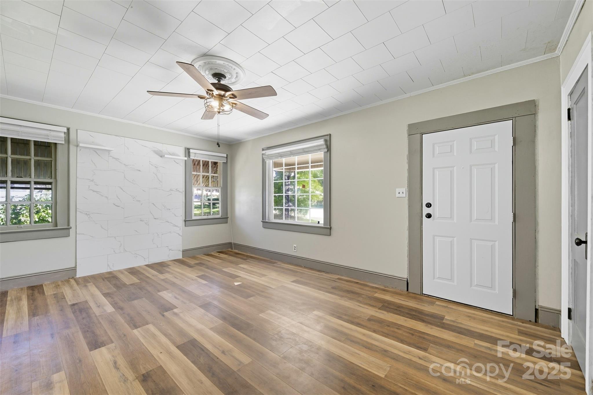 515 Suttle Street Shelby, NC 28150 - Photo 12 of 25 an empty room with windows and fan
