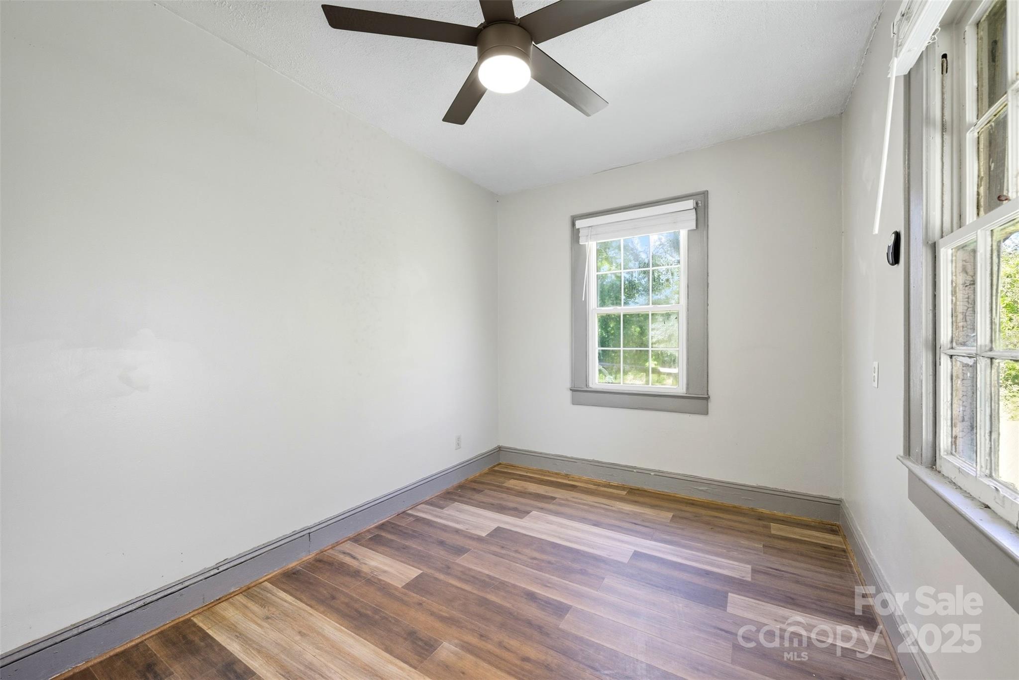515 Suttle Street Shelby, NC 28150 - Photo 15 of 25 a view of an empty room with a window and wooden floor