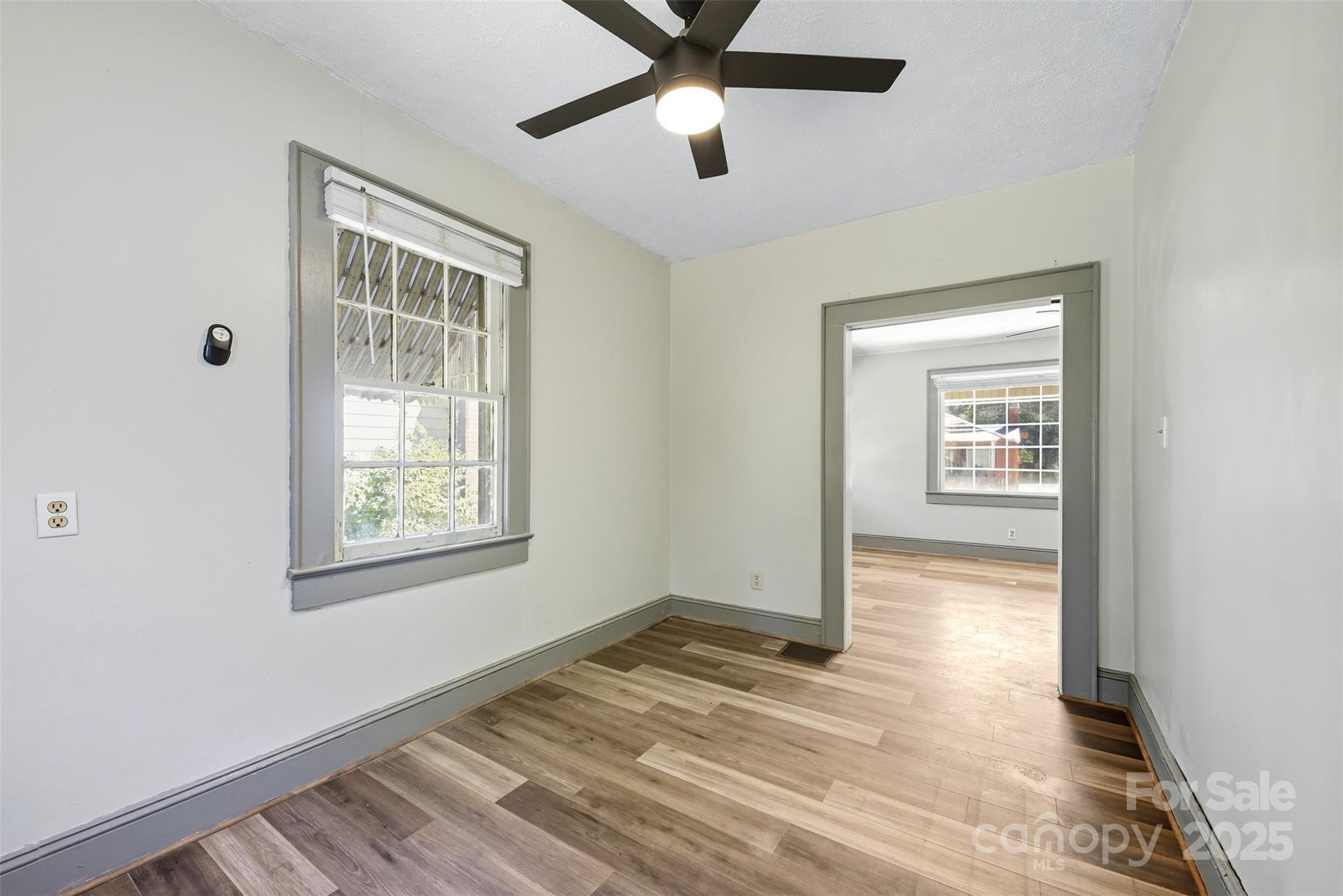 515 Suttle Street Shelby, NC 28150 - Photo 16 of 25 a view of an empty room with wooden floor and a window