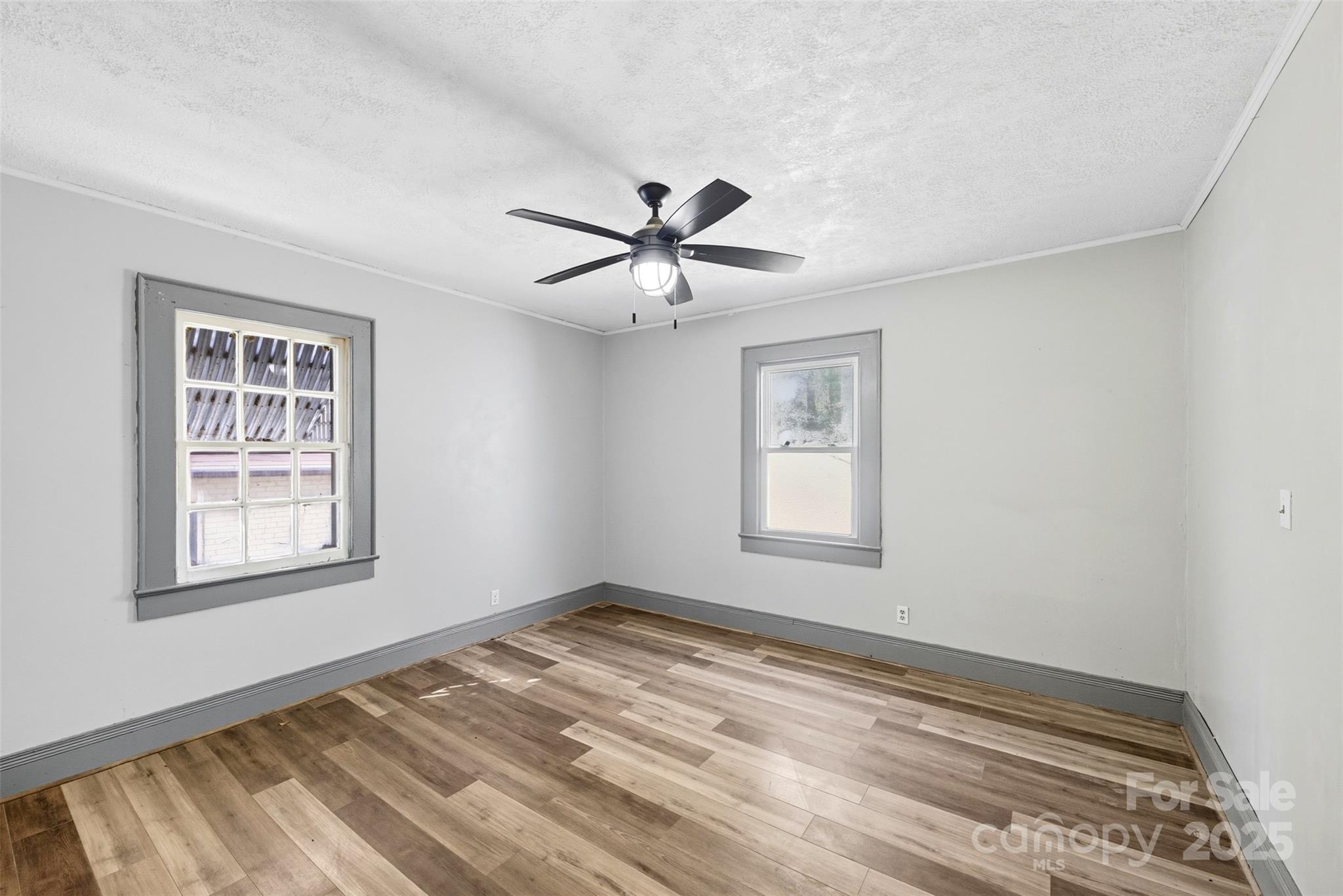515 Suttle Street Shelby, NC 28150 - Photo 17 of 25 a view of empty room with wooden floor and fan
