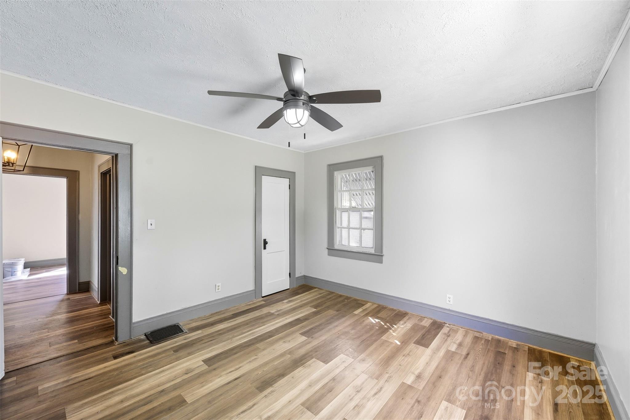 515 Suttle Street Shelby, NC 28150 - Photo 18 of 25 a view of a room with wooden floor and a ceiling fan