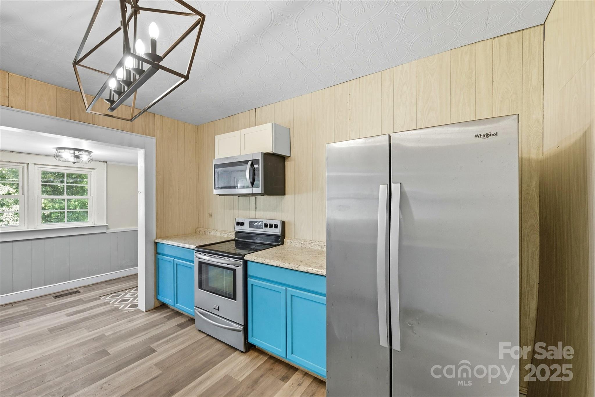 515 Suttle Street Shelby, NC 28150 - Photo 6 of 25 a kitchen with stainless steel appliances granite countertop a refrigerator a stove a sink dishwasher a refrigerator and a dining table with wooden floor