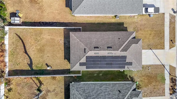 an aerial view of a house with a yard