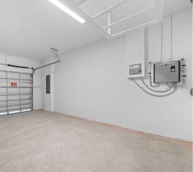 701 Southeast 14th Court Homestead, FL 33034 - Photo 17 of 18 a view of a storage & utility room with racks on the wall