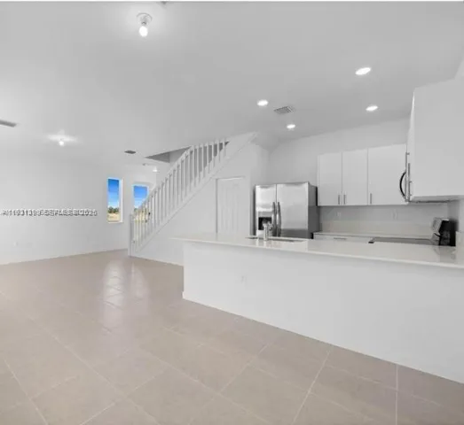 a view of kitchen with cabinets and wooden floor